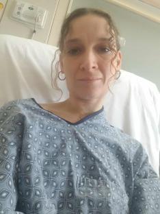 Woman in hospital gown.
