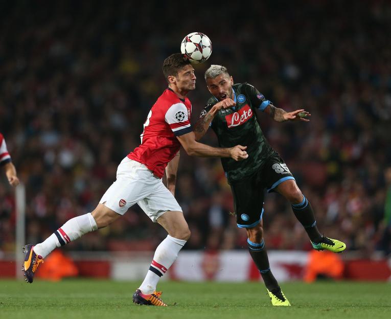 Arsenal's Olivier Giroud and Napoli's Valon Behrami vying for the ball.