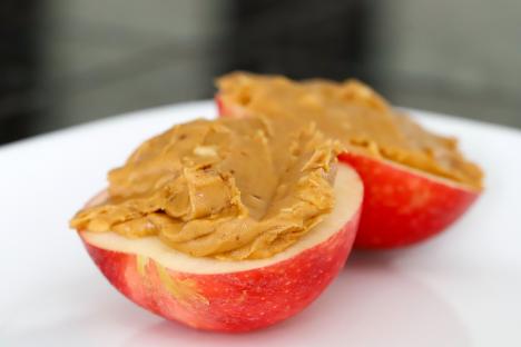 Apple halves filled with crunchy peanut butter.