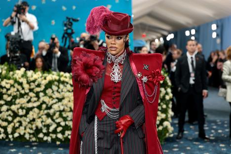 Teyana Taylor at the Met Gala in a red pinstripe suit and hat.