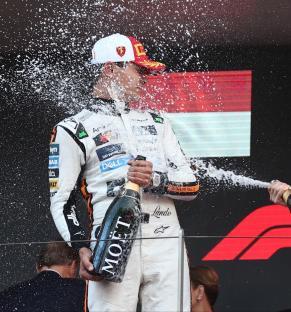 Lando Norris and Oscar Piastri celebrating a Formula 1 win with champagne.