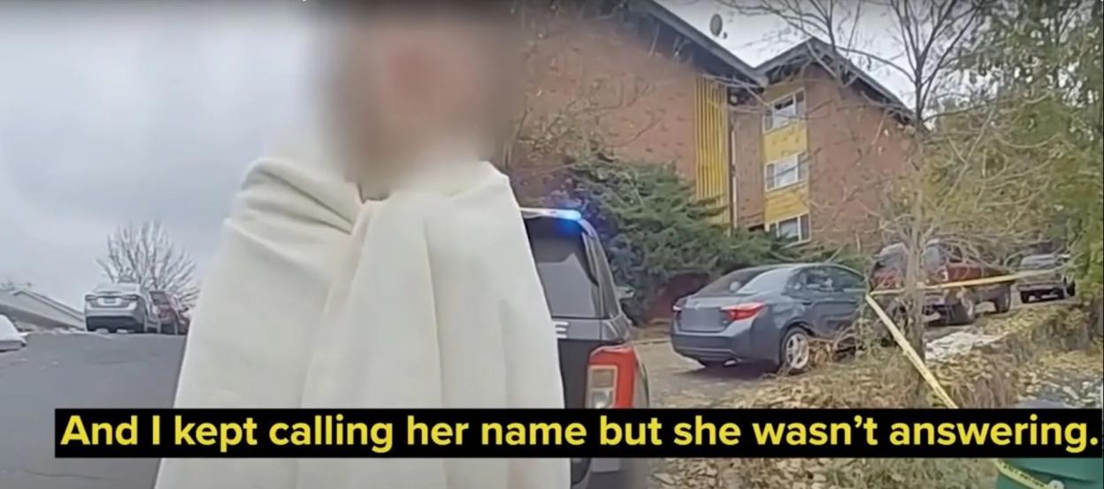 Bodycam footage of a crime scene with a blurred person wrapped in a blanket.