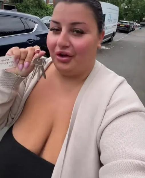 Woman holding keys to her new home.