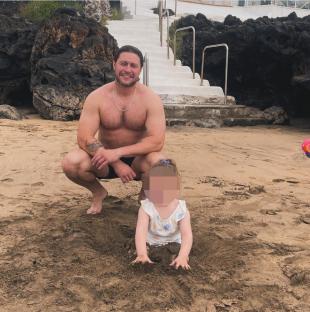 Tony Discipline with a child on a beach.