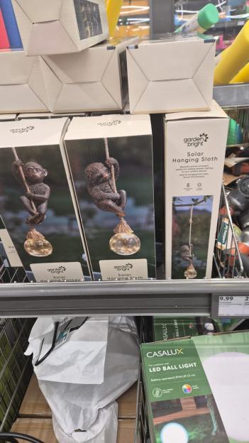 Solar-powered hanging monkey and sloth garden lights.