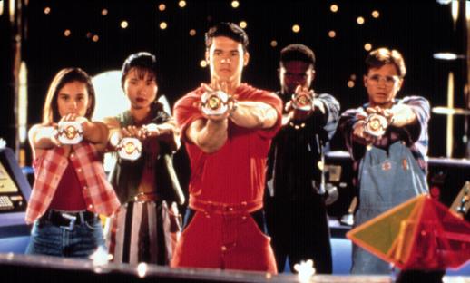 The Mighty Morphin Power Rangers holding their power coins.