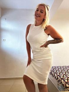 Woman in a white ribbed midi dress.
