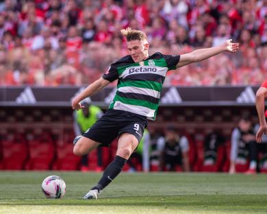 Soccer player kicking the ball during a game.