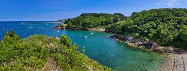 Fishcombe Cove in Brixham, Devon, with Brixham Breakwater Lighthouse in the distance.