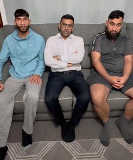 Three brothers sitting on a couch.