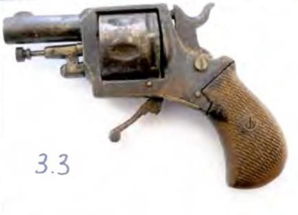 Photo of a revolver next to a ruler.