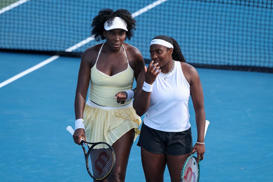 Venus Williams and Hailey Baptiste on a tennis court.
