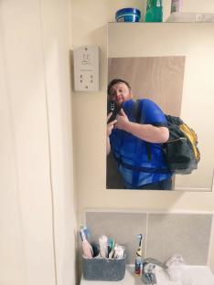Mirror selfie of a darts player working as a plumber.