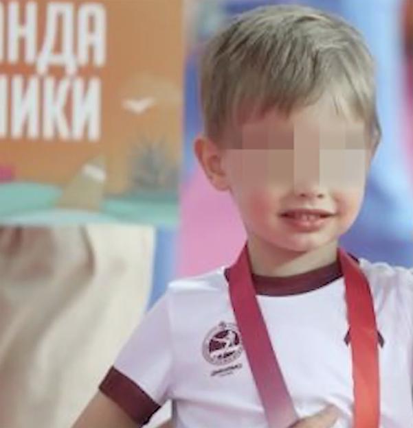 Photo of Vladimir Putin's youngest son with his face blurred.