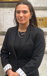 Woman in black blazer.