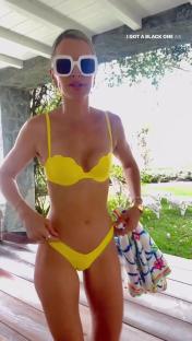 Vogue Williams in a yellow bikini and large white sunglasses.