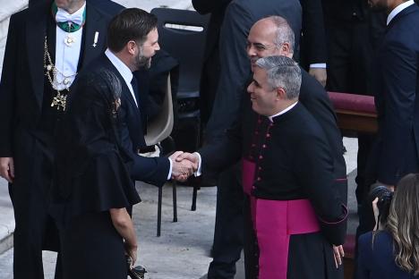 JD Vance and his wife greeting a priest at a Holy Mass.