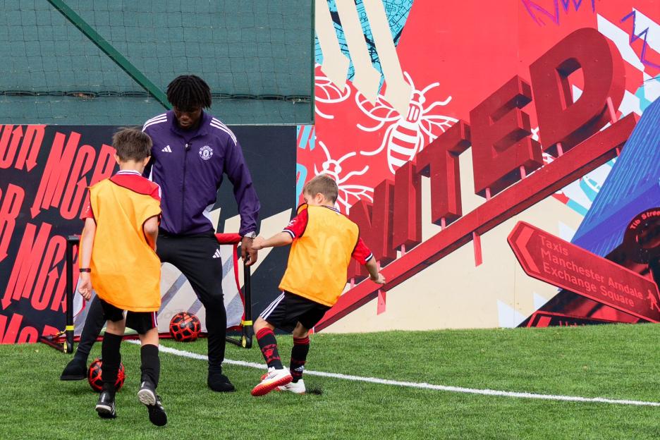 Soccer coach instructing young players.