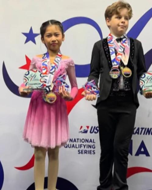 Ice skaters Angela Yang and Sean Kay posing with medals and awards.
