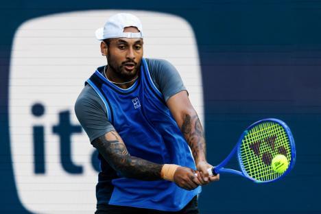 Nick Kyrgios of Australia hitting a backhand in a tennis match.