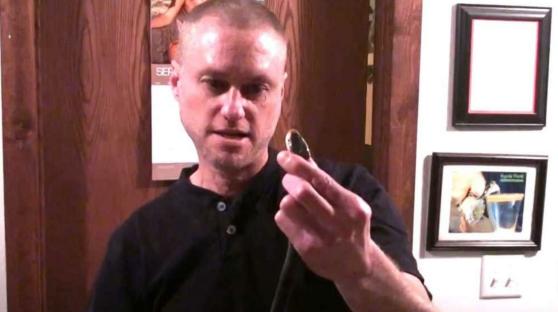 Man holding vial of antibodies that protect against venomous snake bites.