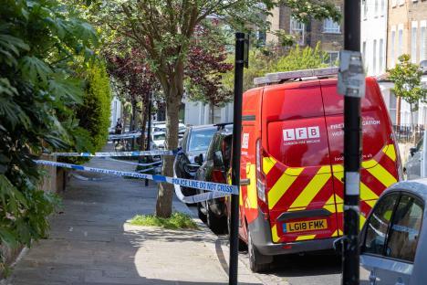London Fire Brigade van parked behind police tape.