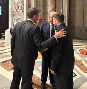 Four men in suits conversing.