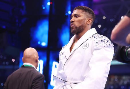 Anthony Joshua in a white robe before a boxing match.