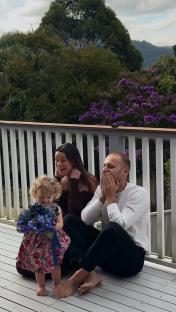 Family on a deck, revealing the gender of their second baby.