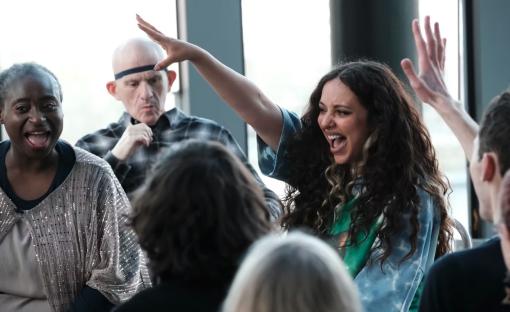 Jade Thirlwall playing a game with a group of people.