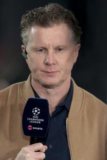 Steve McManaman holding a TNT Sports Champions League microphone.