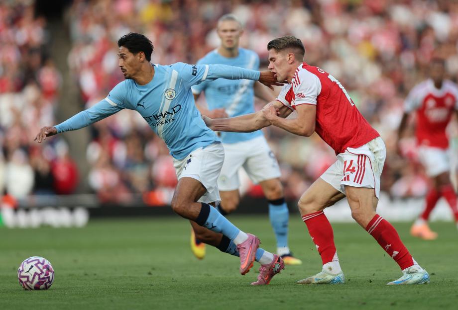 Tijjani Reijnders of Manchester City catches Viktor Gyokeres of Arsenal with his hand during the Premier League match.