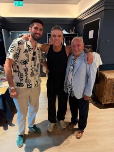 Three men posing for a photo.