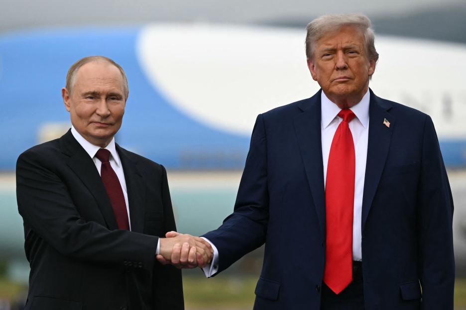 Vladimir Putin and Donald Trump shaking hands.