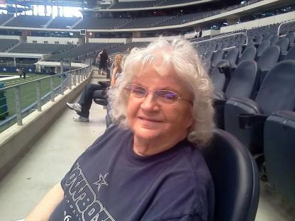Woman in a Cowboys shirt at a stadium.