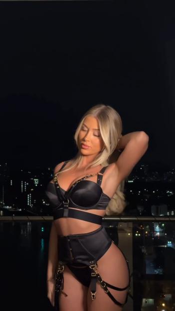Jess Gale modeling bondage-inspired lingerie and a see-through bodysuit.