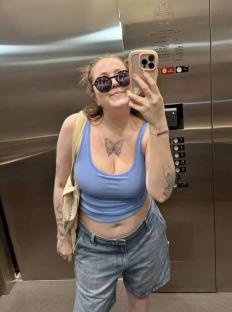 Woman taking a selfie in an elevator.