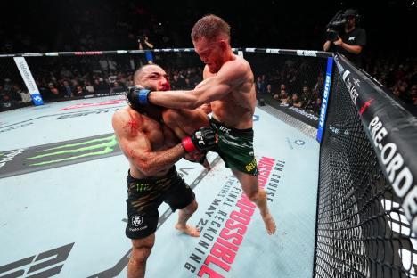UFC welterweight championship bout: Jack Della Maddalena knees Belal Muhammad.