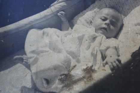Baby sleeping in a crib on VE Day.