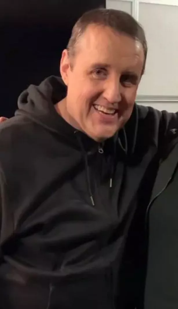 Peter Kay in a black hoodie.
