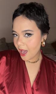 Close-up portrait of a woman with short hair and red lipstick.