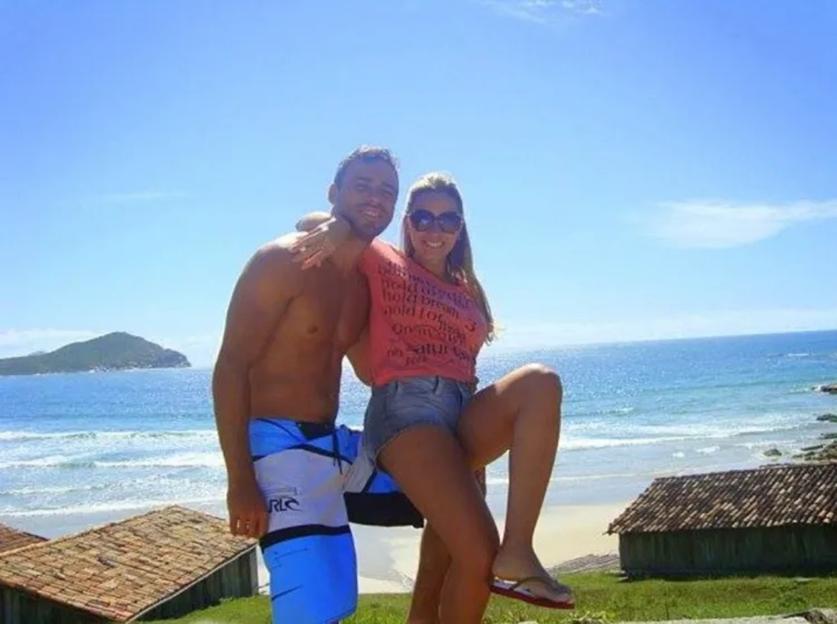 Ana and Jeferson pose in front of a beach in Sao Jose, Brazil.