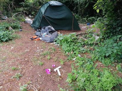 Fly-tipped drugs paraphernalia and a tent near tennis courts.
