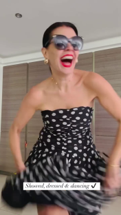Woman in polka dot dress dancing.