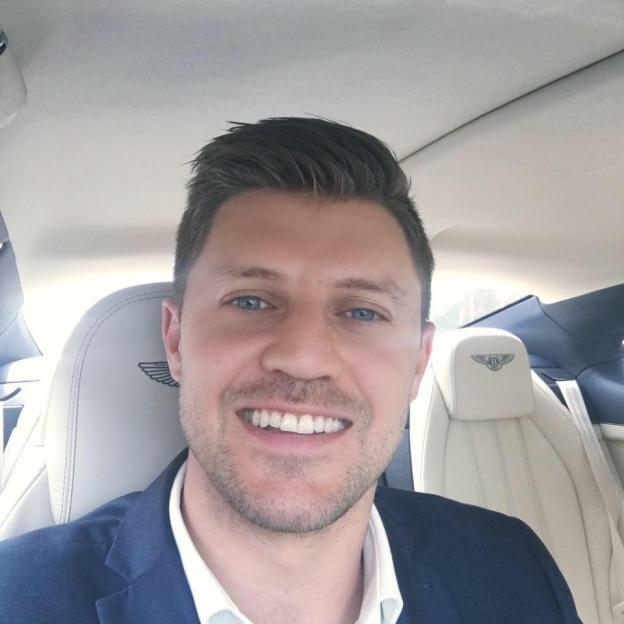 Selfie of a man in a Bentley.