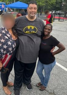 A man and two women posing for a photo.