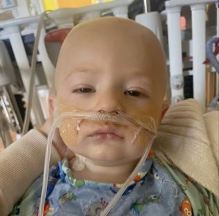 A toddler on life support in a hospital after swallowing a button battery.