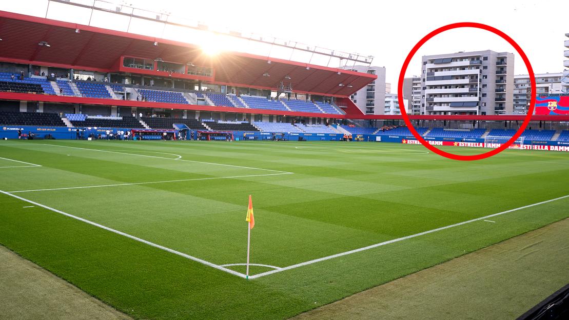 A soccer stadium with an apartment building visible outside, highlighted by a red circle.