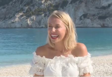 Laura Hamilton on a beach, smiling.