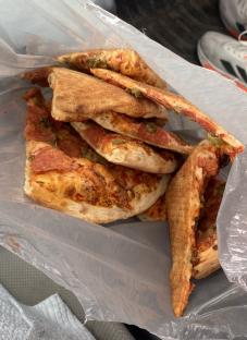 Pizza slices in a plastic bag.